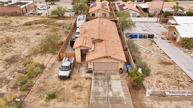 an aerial view of residential houses with outdoor space