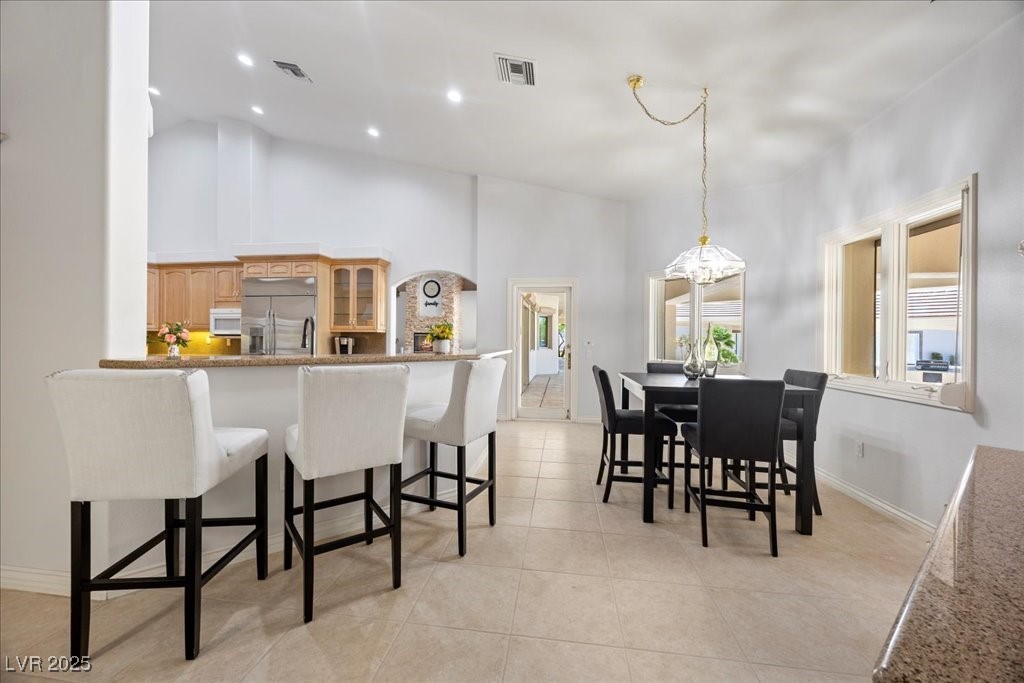 640 Quail Covey Road Henderson, NV 89002 - Photo 23 of 75 Dining space with light tile patterned flooring, high vaulted ceiling, and recessed lighting