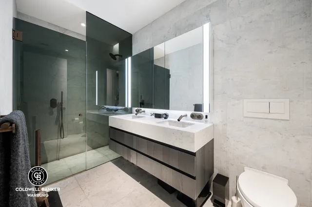 a bathroom with a sink a toilet and mirror