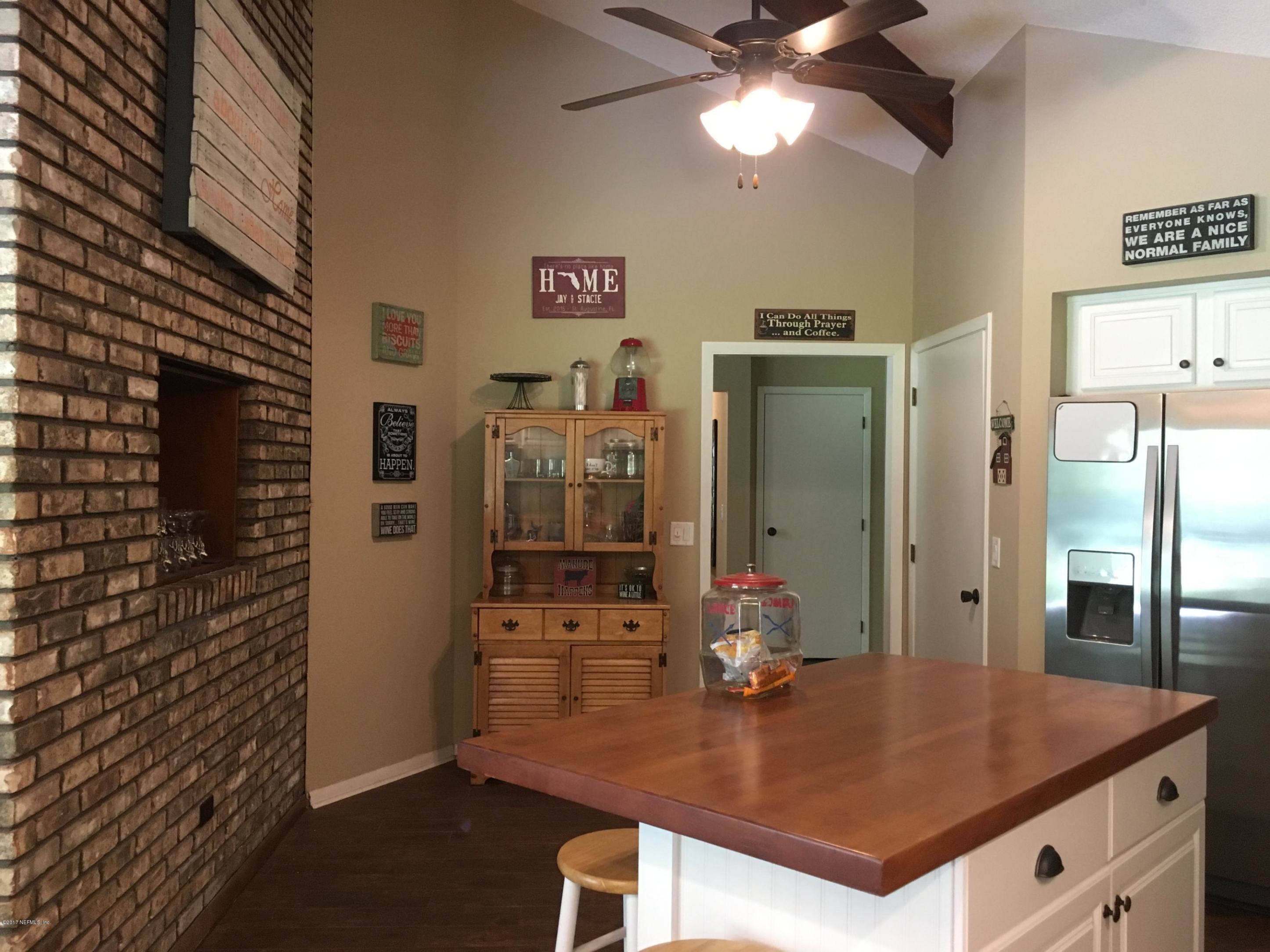 3098 Pacetti Road, Unit LOT I St. Augustine, FL 32092 - Photo 12 of 37 a room with stainless steel appliances kitchen island granite countertop a refrigerator a stove and a sink with wooden floor