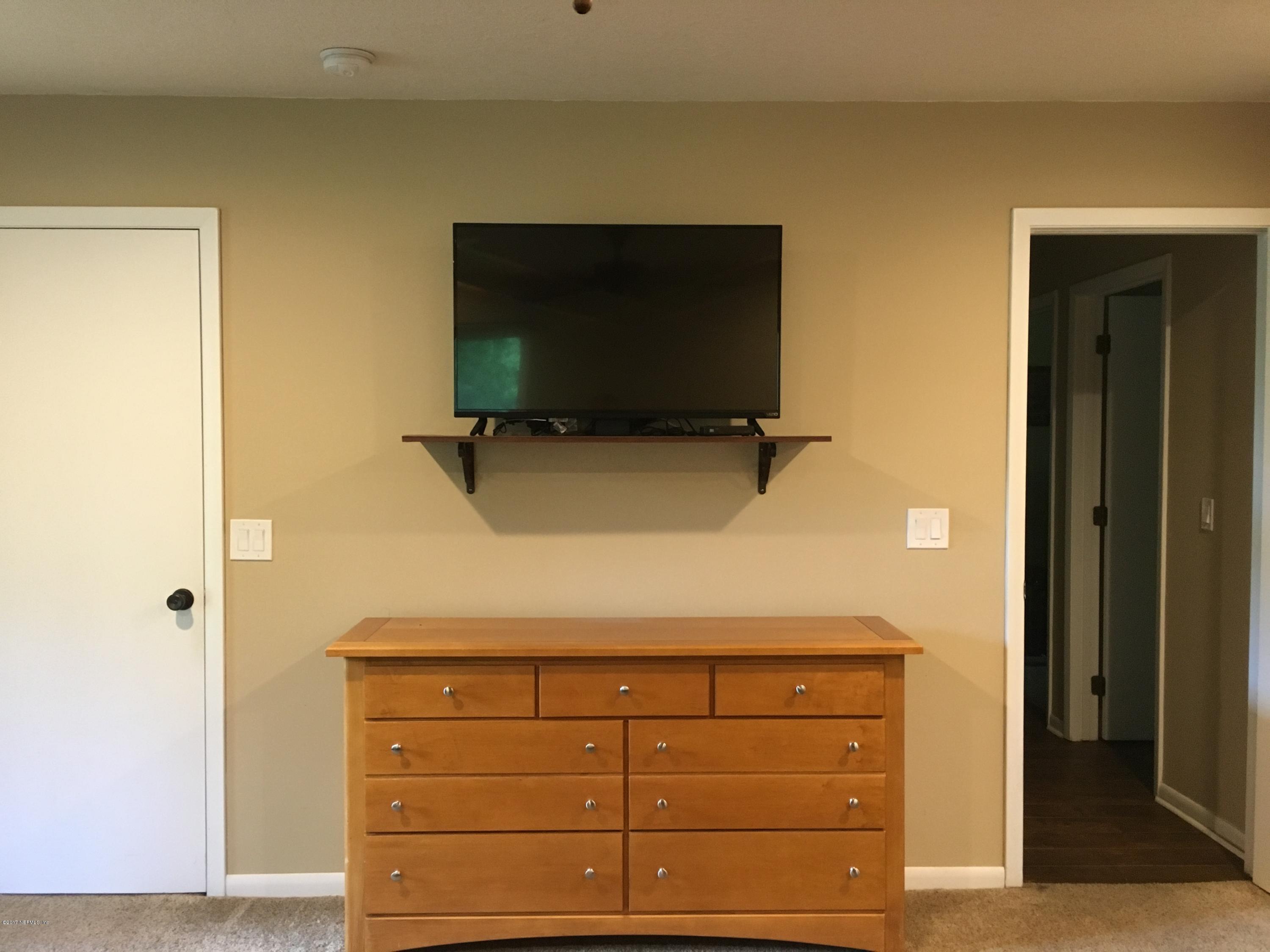 3098 Pacetti Road, Unit LOT I St. Augustine, FL 32092 - Photo 24 of 37 a living room with closet and flat screen tv