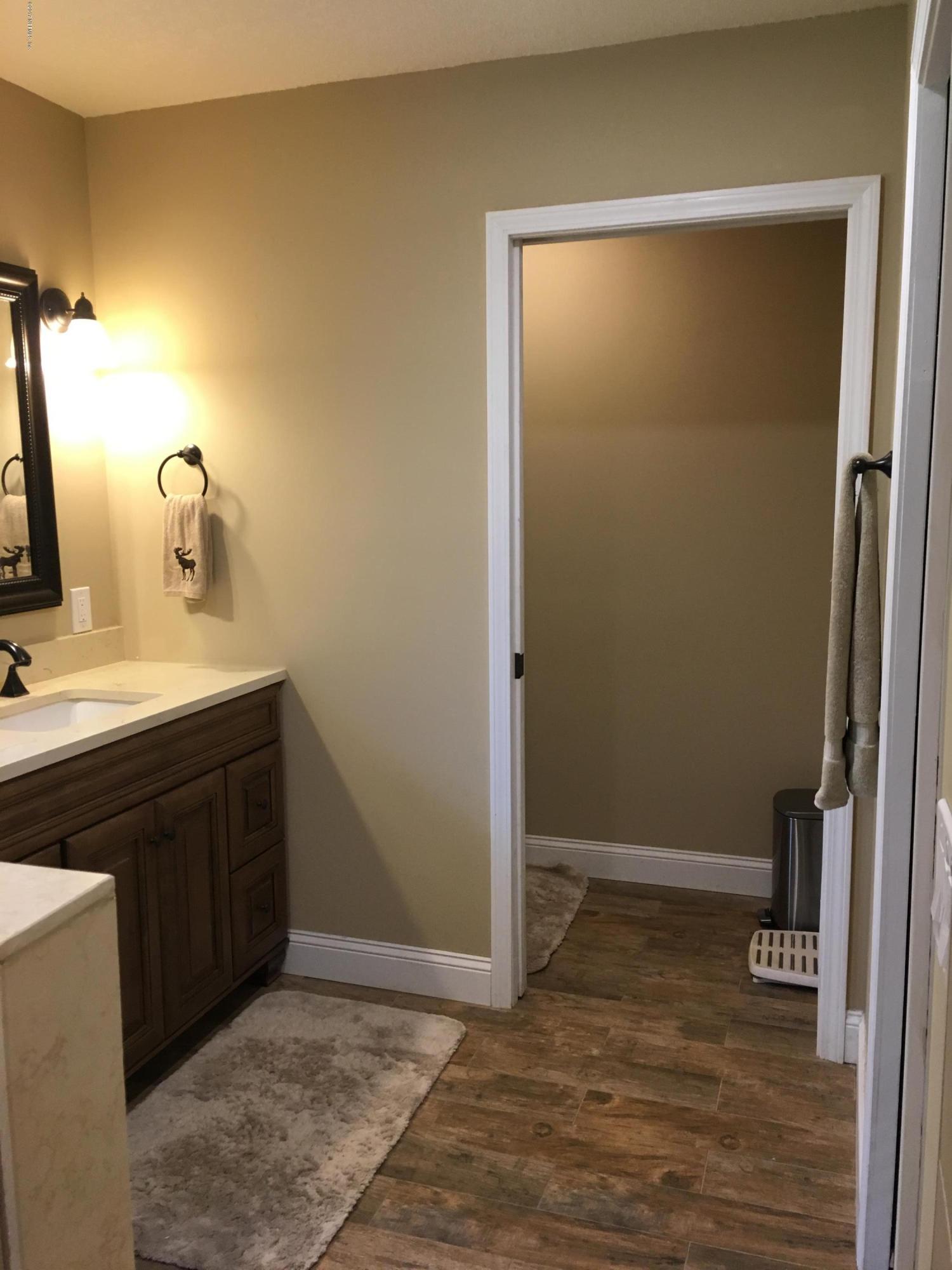 3098 Pacetti Road, Unit LOT I St. Augustine, FL 32092 - Photo 25 of 37 a bathroom with a sink and a mirror