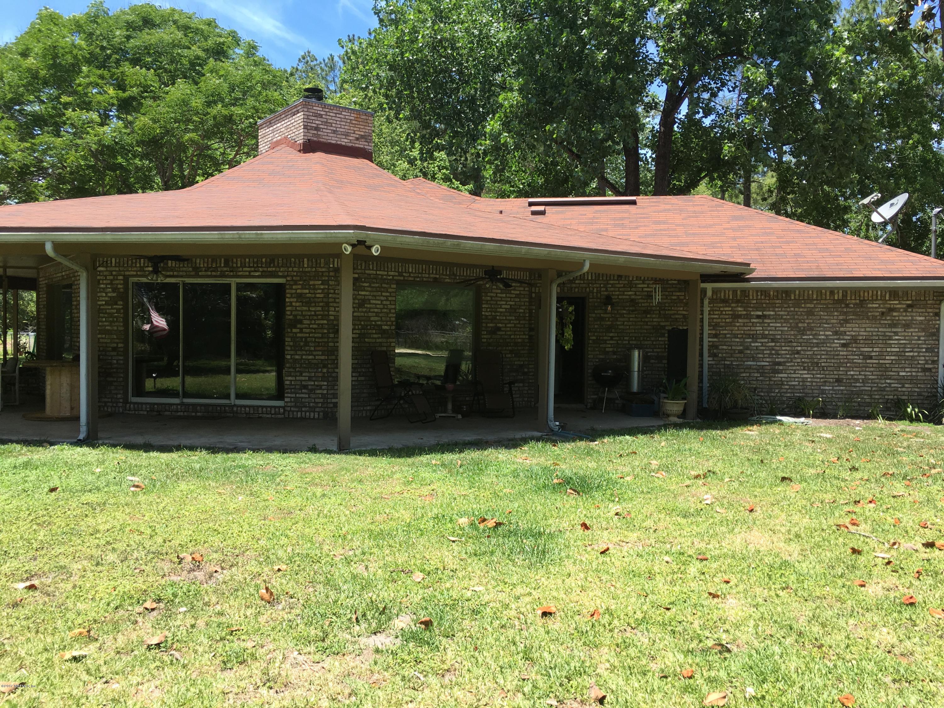 3098 Pacetti Road, Unit LOT I St. Augustine, FL 32092 - Photo 36 of 37 a front view of a house with a yard