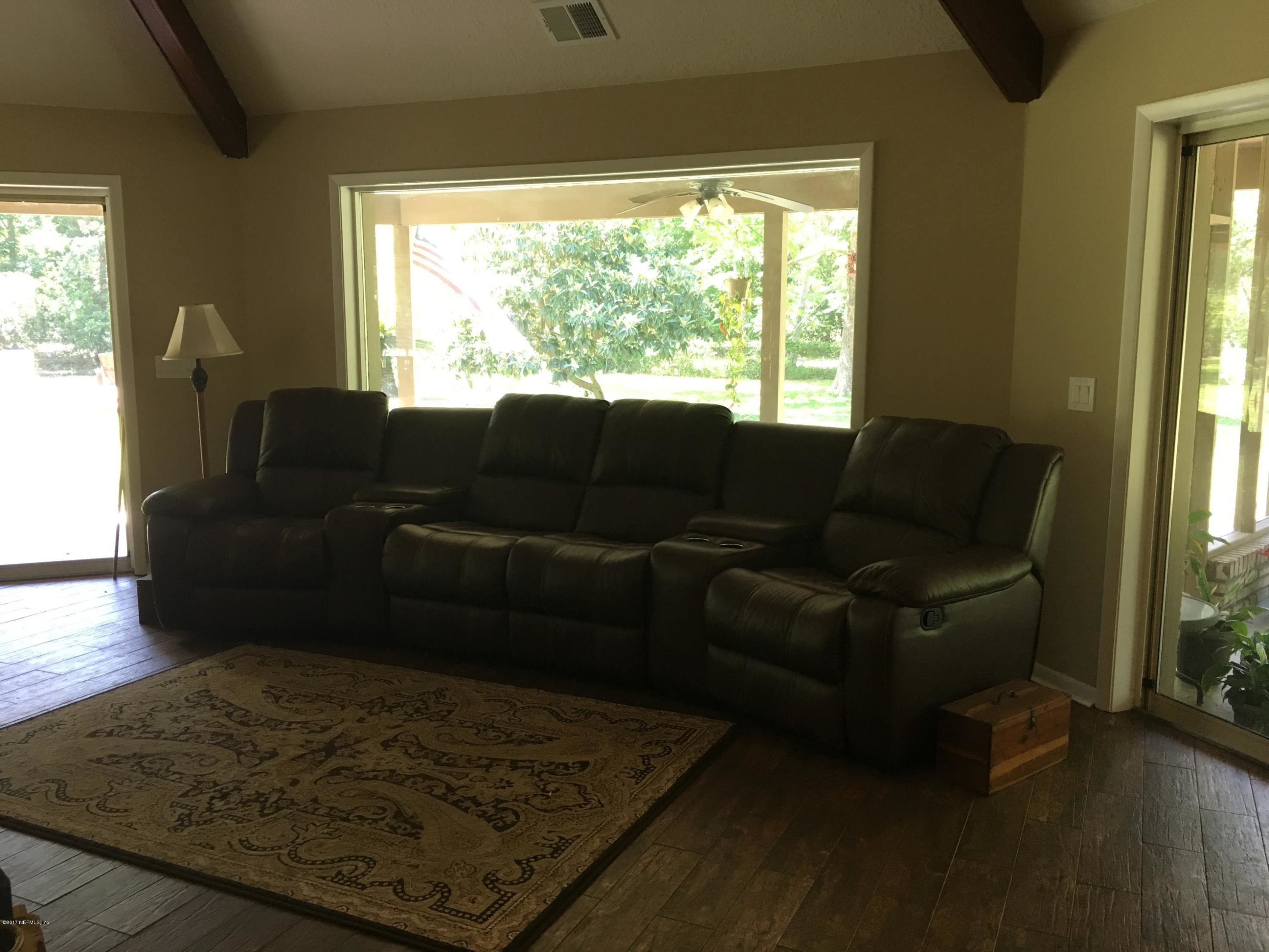 3098 Pacetti Road, Unit LOT I St. Augustine, FL 32092 - Photo 6 of 37 a living room with furniture and a rug