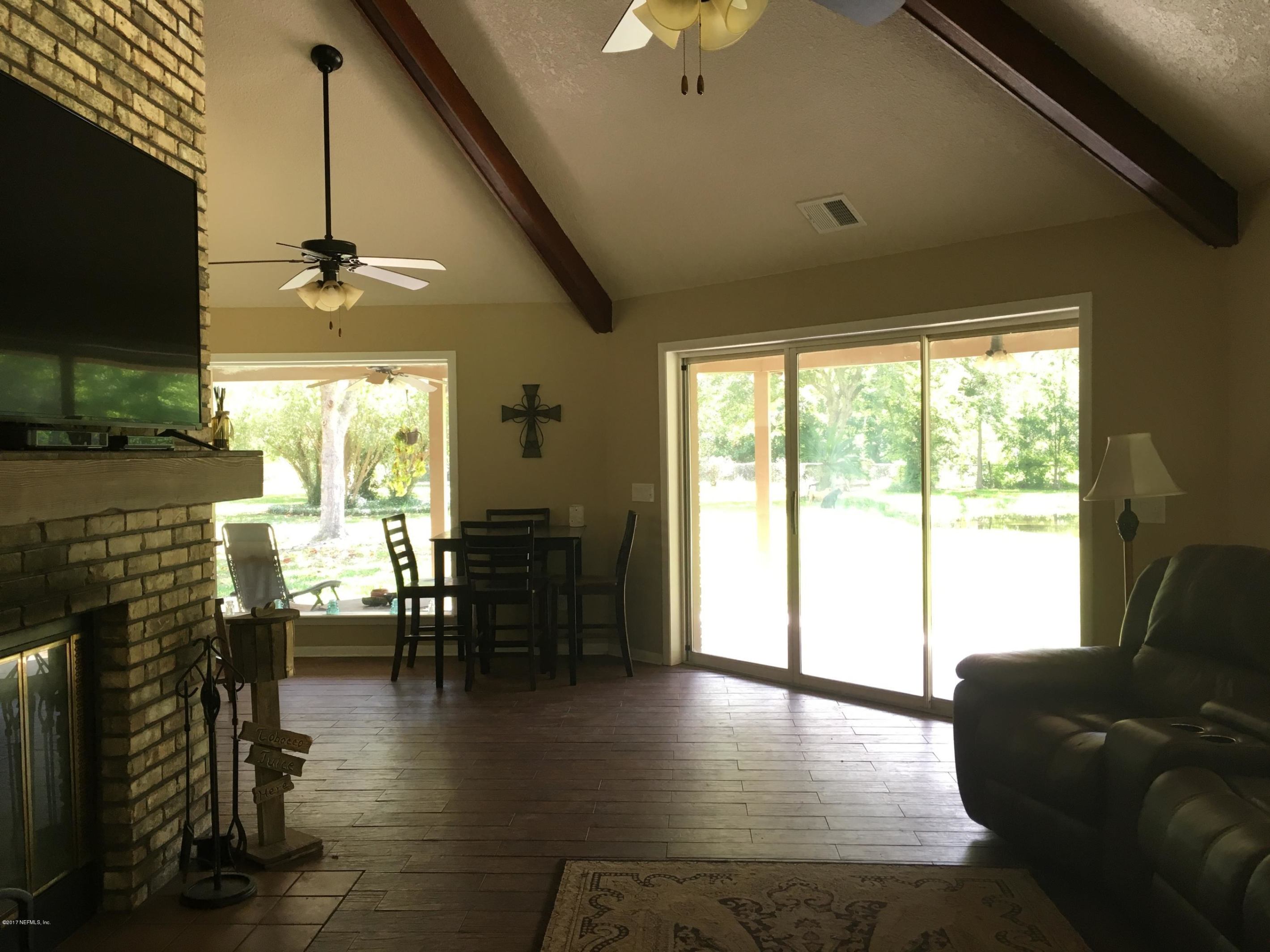 3098 Pacetti Road, Unit LOT I St. Augustine, FL 32092 - Photo 7 of 37 a living room with fireplace furniture and a flat screen tv