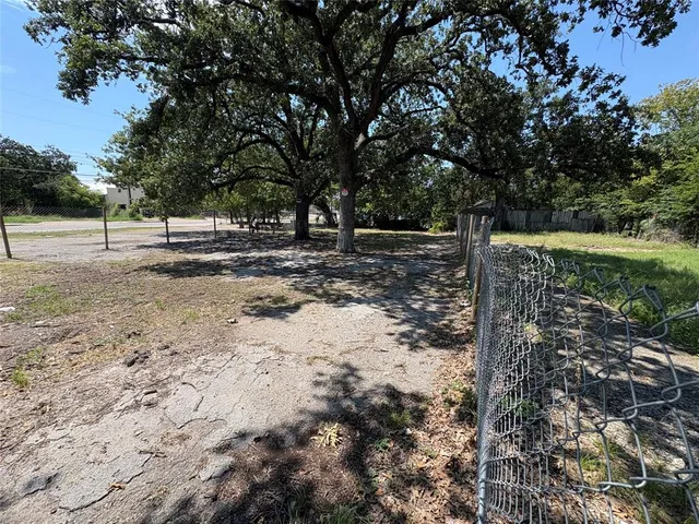 a view of a yard with large trees