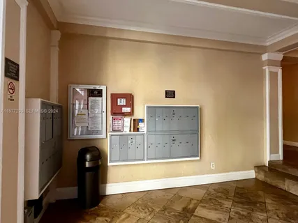 a view of a kitchen with refrigerator and wooden floor