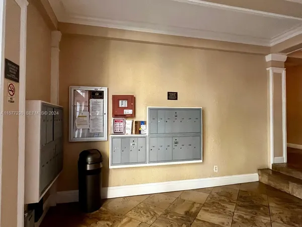 a view of a kitchen with refrigerator and wooden floor