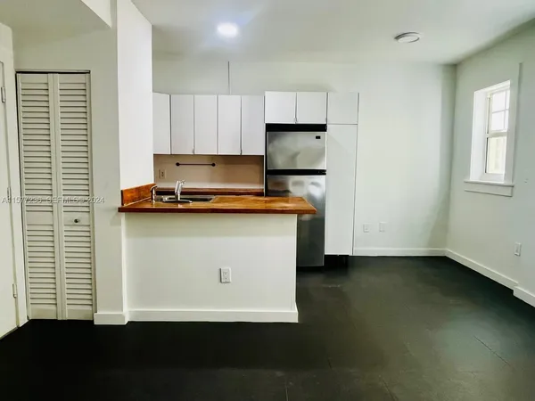 a view of kitchen with wooden floor and a window