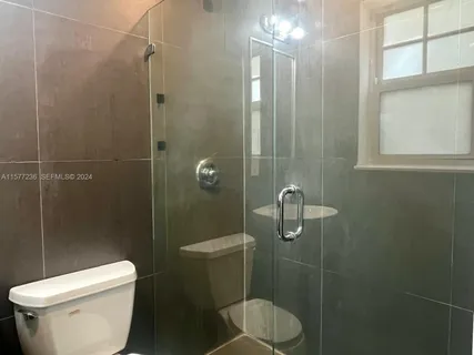 a white toilet sitting next to a bathroom sink