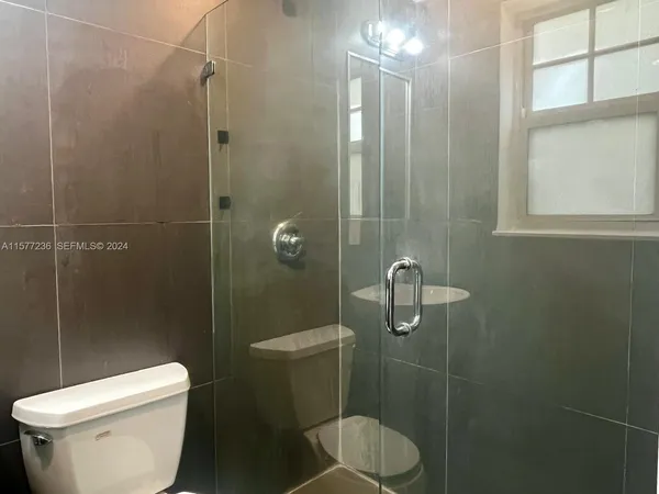 a white toilet sitting next to a bathroom sink