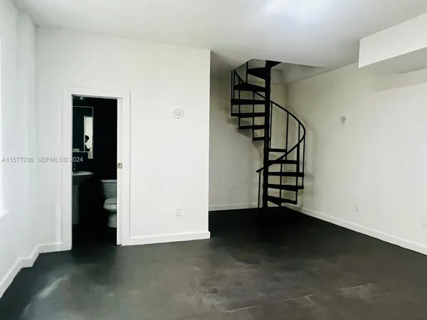 an empty room with windows and natural light