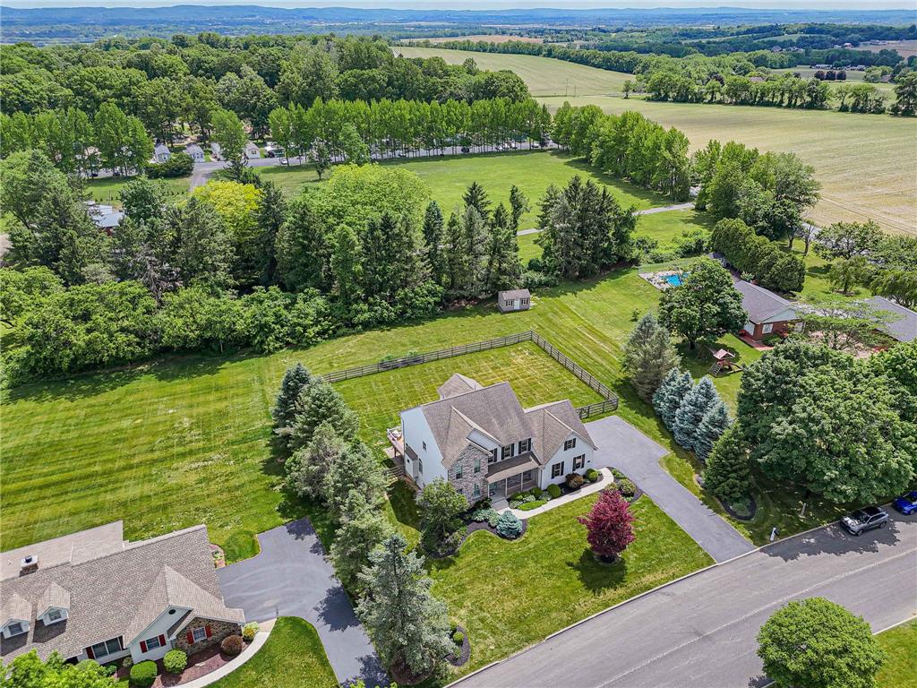 6000 Pond View Terrace Bath, PA 18014 - Photo 7 of 69 An aerial perspective reveals a charming residence nestled amidst verdant fields, offering a private and ample fenced yard.