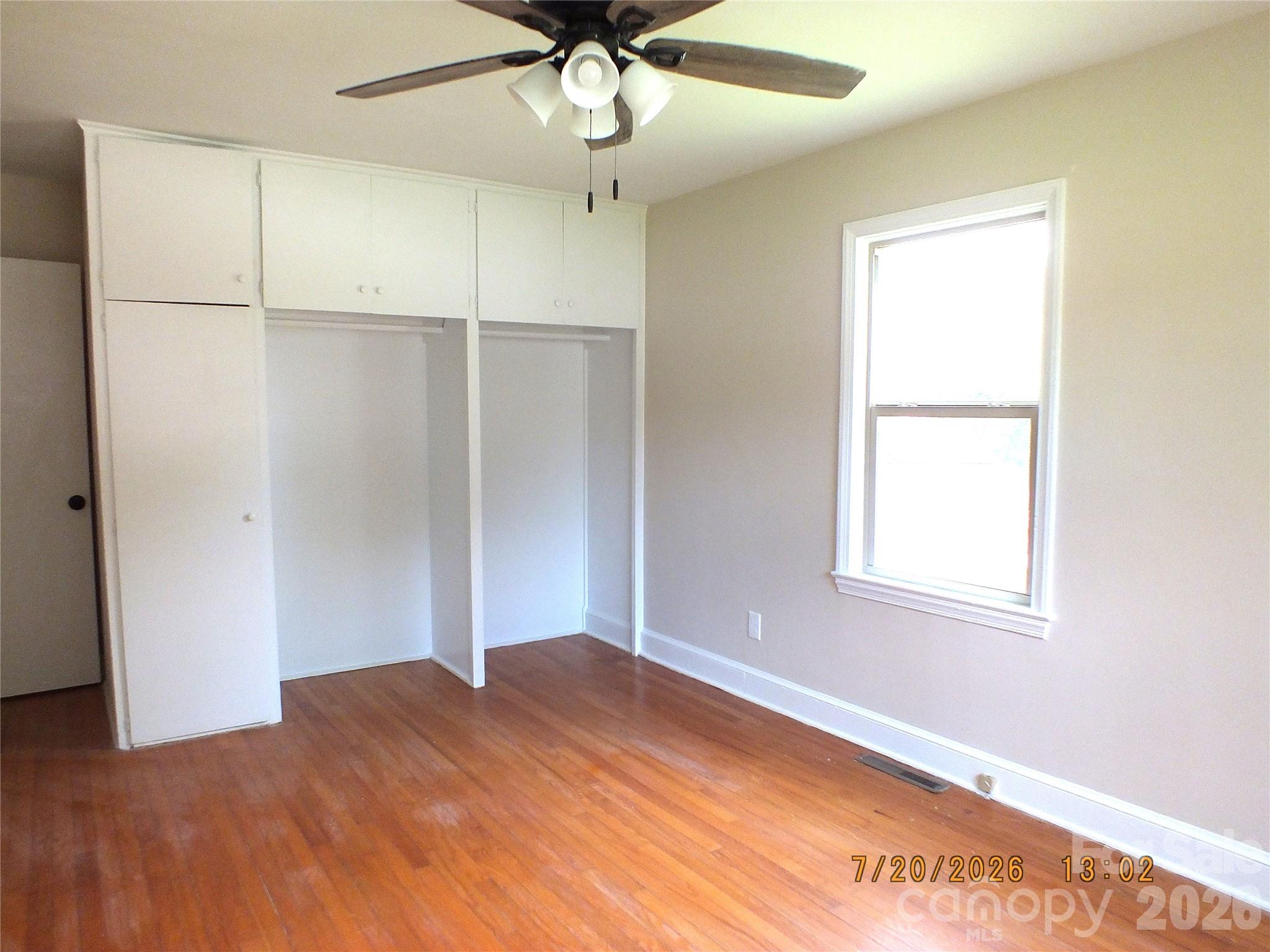 414 West Springs Street Lancaster, SC 29720 - Photo 18 of 22 an empty room with a window and a ceiling fan
