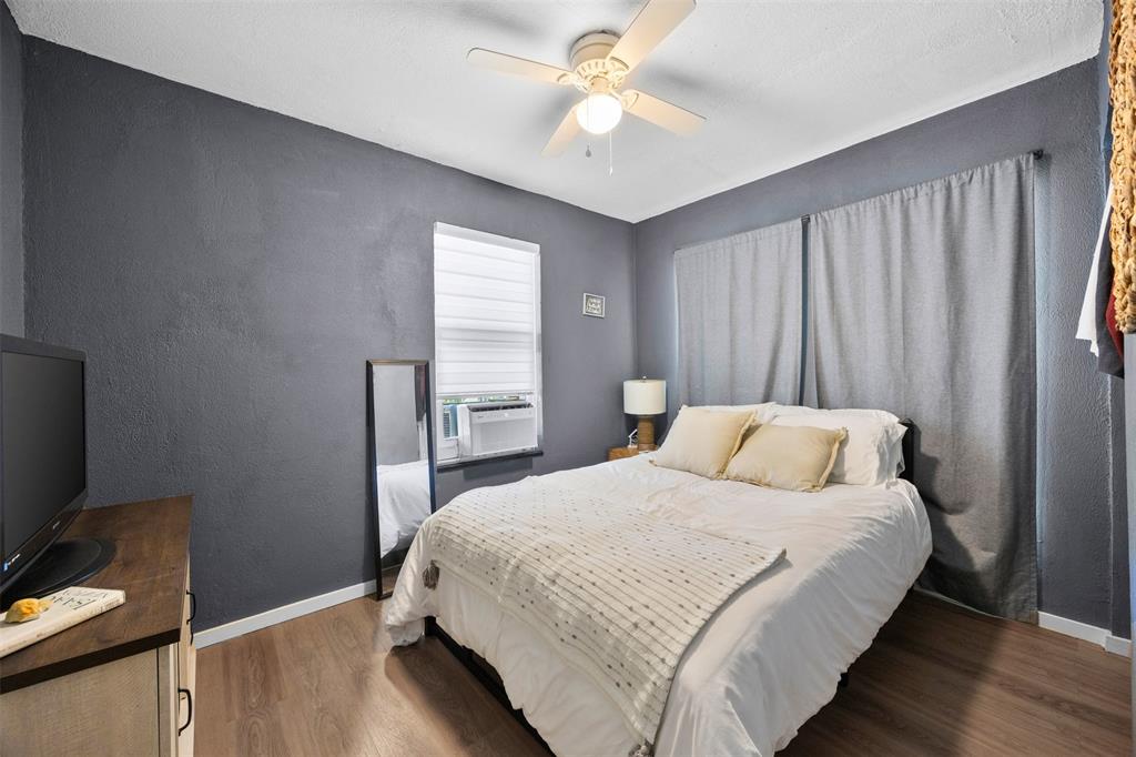 7110 Apache Circle Mabank, TX 75156 - Photo 22 of 39 Bedroom featuring wood-finish flooring, a ceiling fan with integrated lighting, and a window with white blinds
