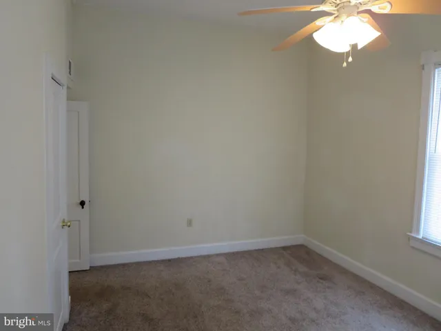 an empty room with closet area
