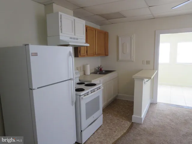 a white refrigerator freezer sitting in a kitchen