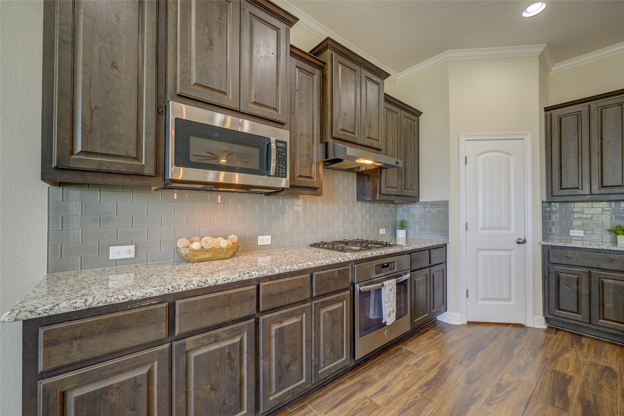 409 Betony Loop Buda, TX 78610 - Photo 11 of 38 Granite counters and stainless steel appliances outfit this functional, well-lit kitchen.