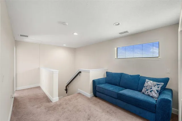 a living room with furniture and a ceiling fan