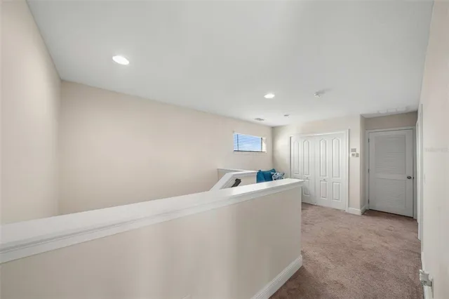 a bedroom with a bed next to a window with a flat screen tv