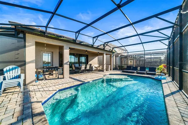 a view of swimming pool with sitting area