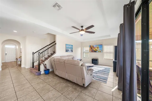 a living room with furniture and a chandelier