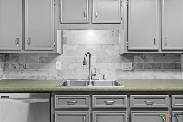 a kitchen with a sink and cabinets