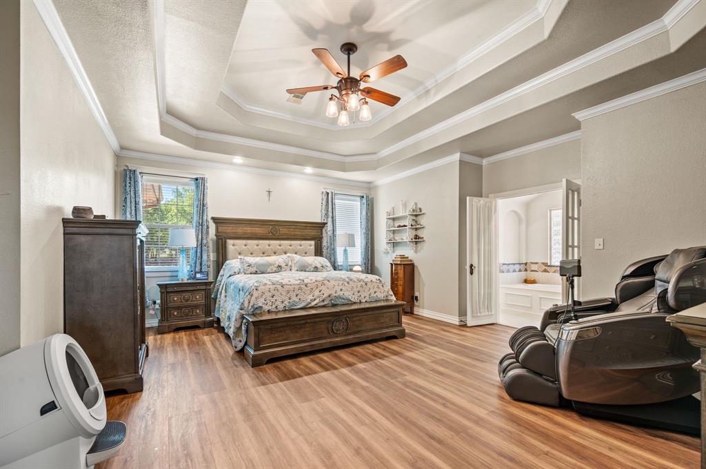 1216 W Road Waxahachie, TX 75165 - Photo 14 of 40 a bedroom with a bed window and a ceiling fan