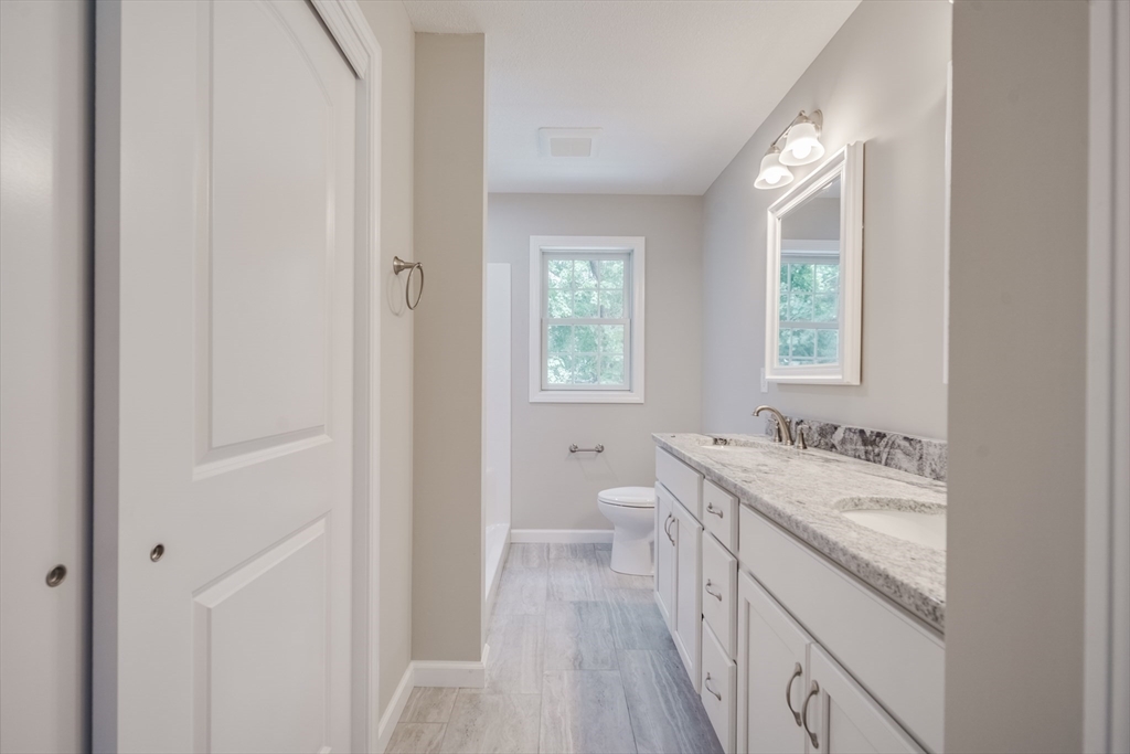 10 Kittrell Street Springfield, MA 01119 - Photo 31 of 42 a bathroom with a sink a vanity and a large mirror