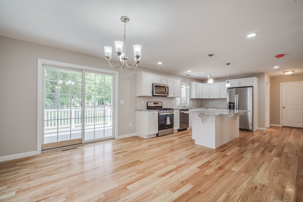 10 Kittrell Street Springfield, MA 01119 - Photo 6 of 42 a large kitchen with cabinets wooden floor and stainless steel appliances