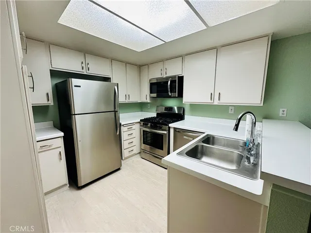 a kitchen with a refrigerator sink and stove