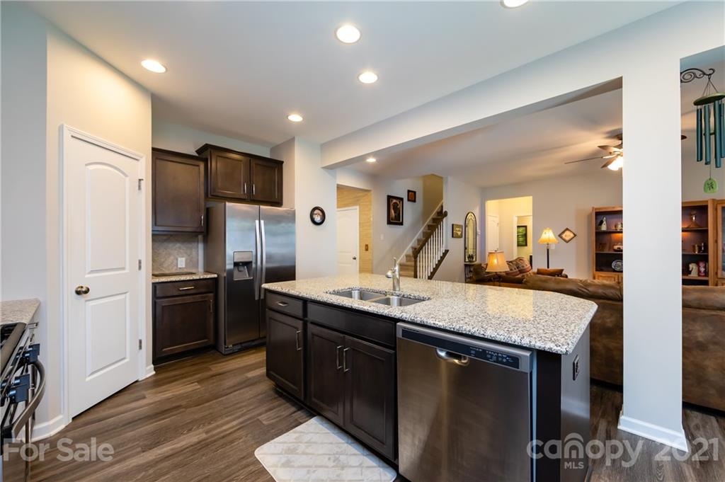 4822 Abendego Road Charlotte, NC 28213 - Photo 16 of 48 a kitchen with stainless steel appliances granite countertop a sink refrigerator and cabinets