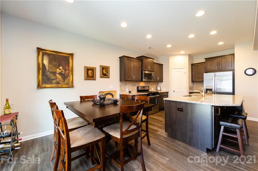 4822 Abendego Road Charlotte, NC 28213 - Photo 18 of 48 a view of a dining room with furniture and wooden floor