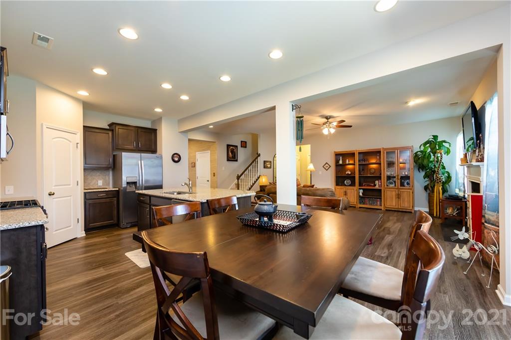 4822 Abendego Road Charlotte, NC 28213 - Photo 19 of 48 a kitchen with a dining table chairs refrigerator and dining table