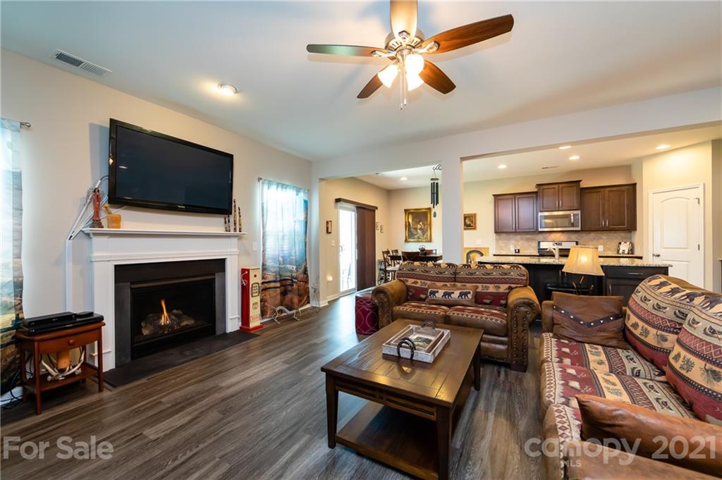 4822 Abendego Road Charlotte, NC 28213 - Photo 20 of 48 a living room with furniture a flat screen tv and a fireplace