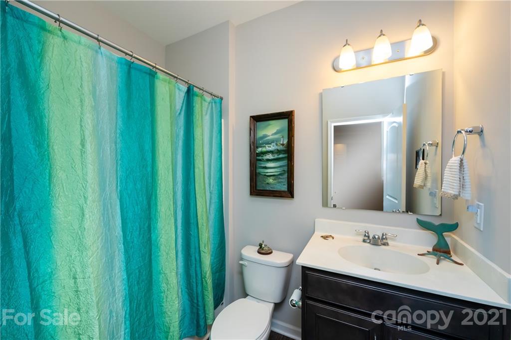 4822 Abendego Road Charlotte, NC 28213 - Photo 24 of 48 a bathroom with a sink a toilet and a mirror