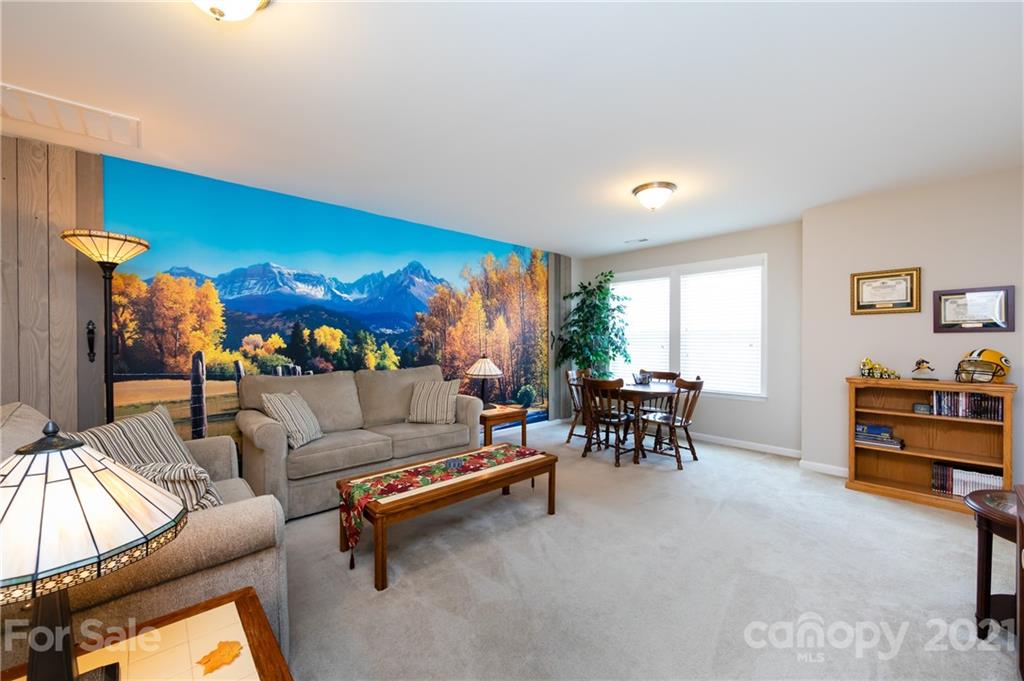 4822 Abendego Road Charlotte, NC 28213 - Photo 27 of 48 a living room with furniture and a dining table