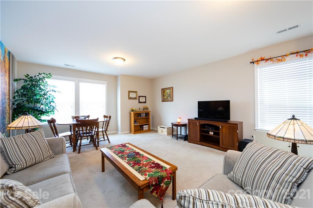 4822 Abendego Road Charlotte, NC 28213 - Photo 28 of 48 a living room with furniture a flat screen tv and a large window