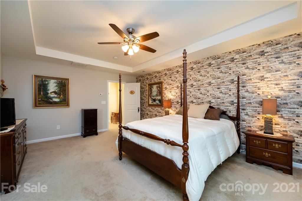 4822 Abendego Road Charlotte, NC 28213 - Photo 30 of 48 a bed room with a bed and a ceiling fan