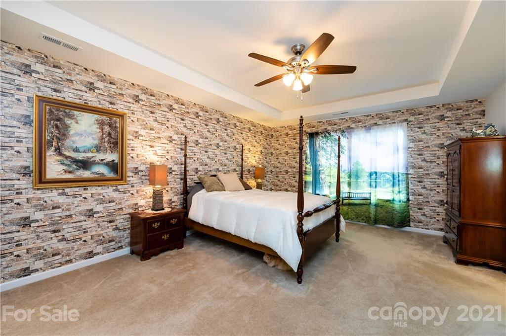 4822 Abendego Road Charlotte, NC 28213 - Photo 31 of 48 a bedroom with a bed and a flat screen tv