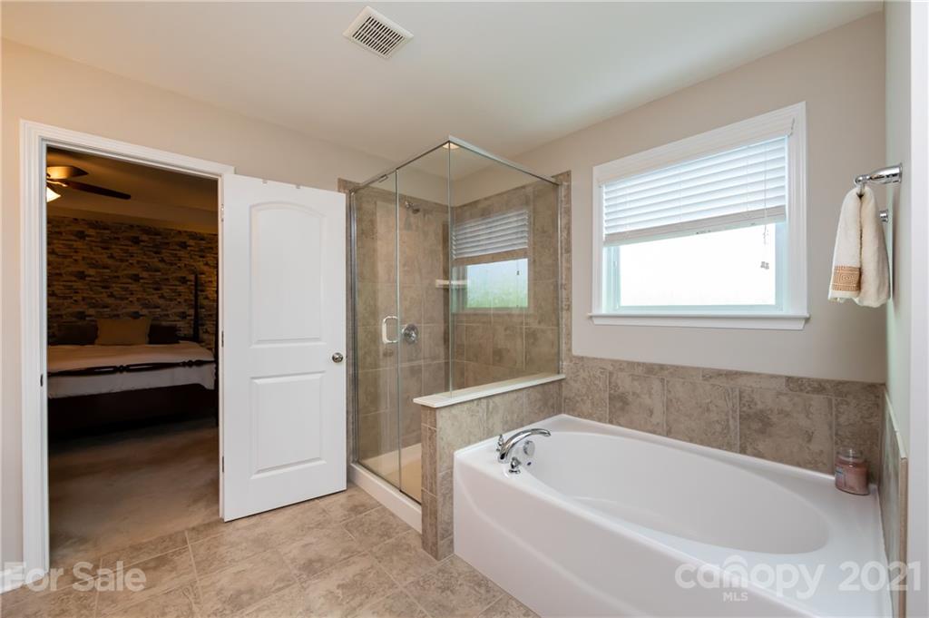 4822 Abendego Road Charlotte, NC 28213 - Photo 33 of 48 a bathroom with a tub shower and sink