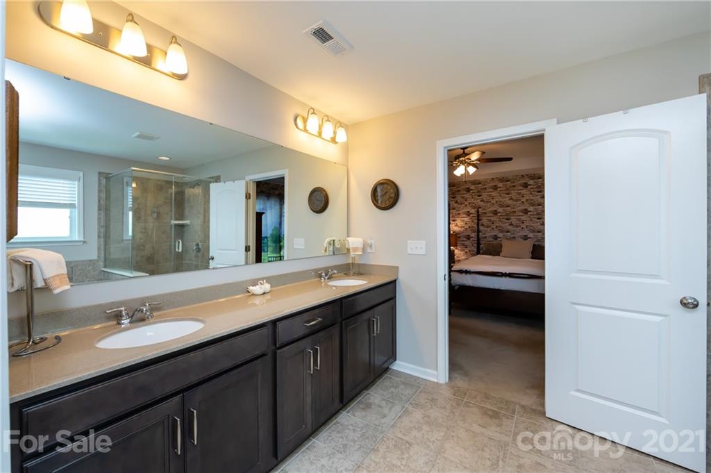 4822 Abendego Road Charlotte, NC 28213 - Photo 35 of 48 a bathroom with a double vanity sink and a mirror