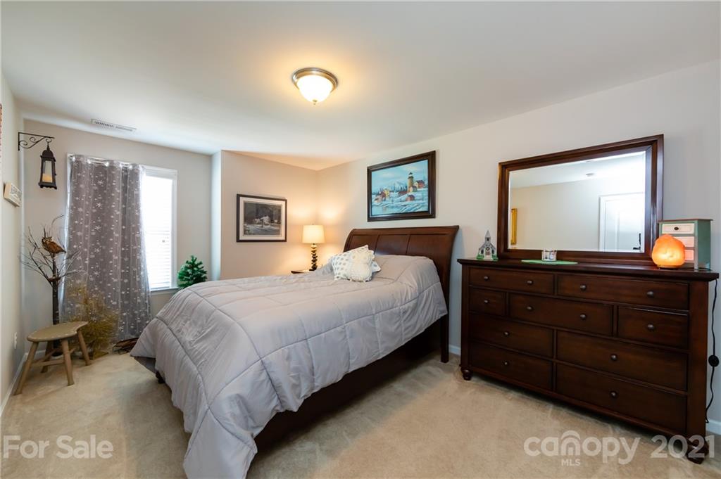 4822 Abendego Road Charlotte, NC 28213 - Photo 37 of 48 a bedroom with a bed and a large mirror on dresser
