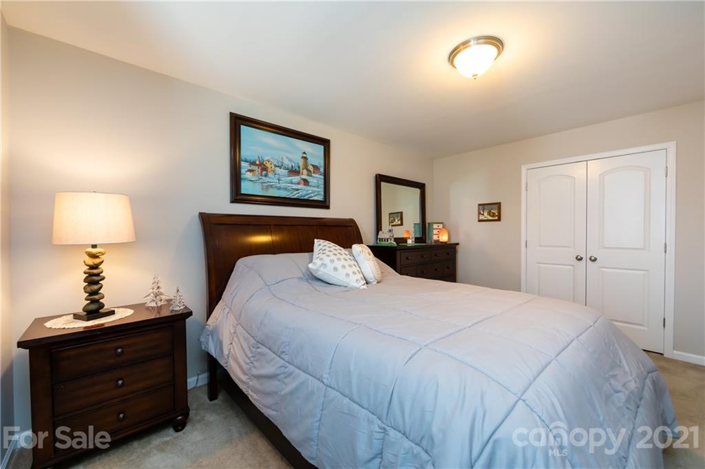 4822 Abendego Road Charlotte, NC 28213 - Photo 38 of 48 a bedroom with a bed and a lamp on dresser