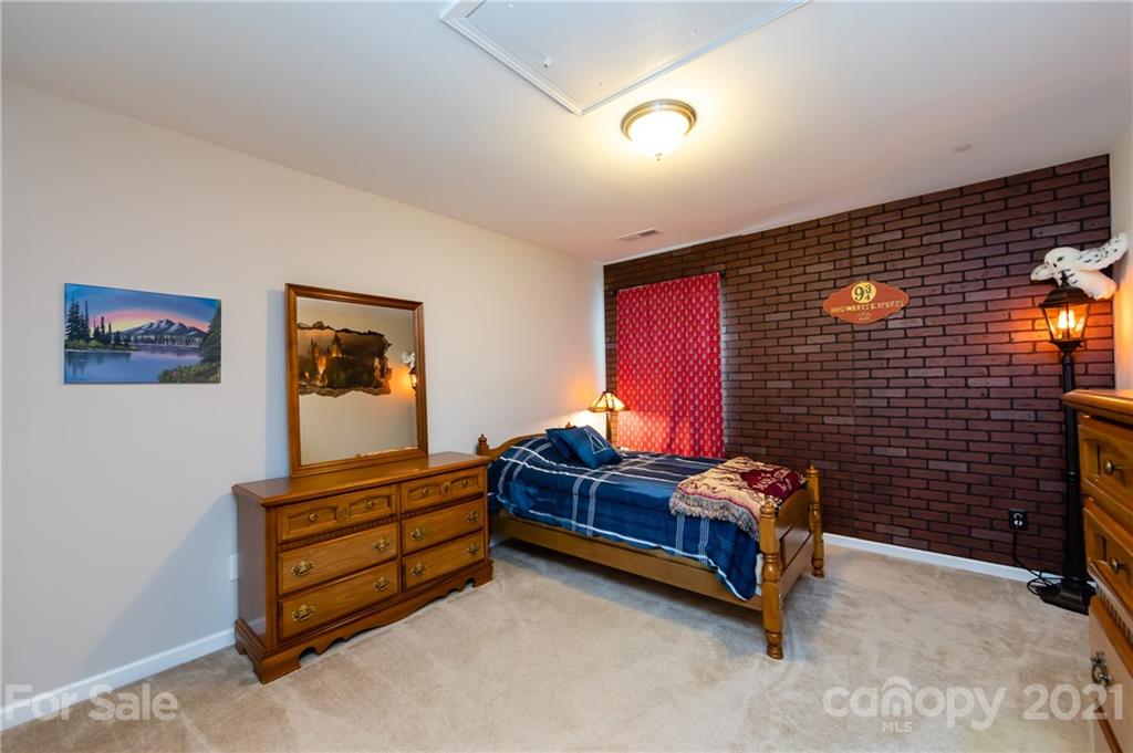 4822 Abendego Road Charlotte, NC 28213 - Photo 42 of 48 a bedroom with furniture and a flat screen tv