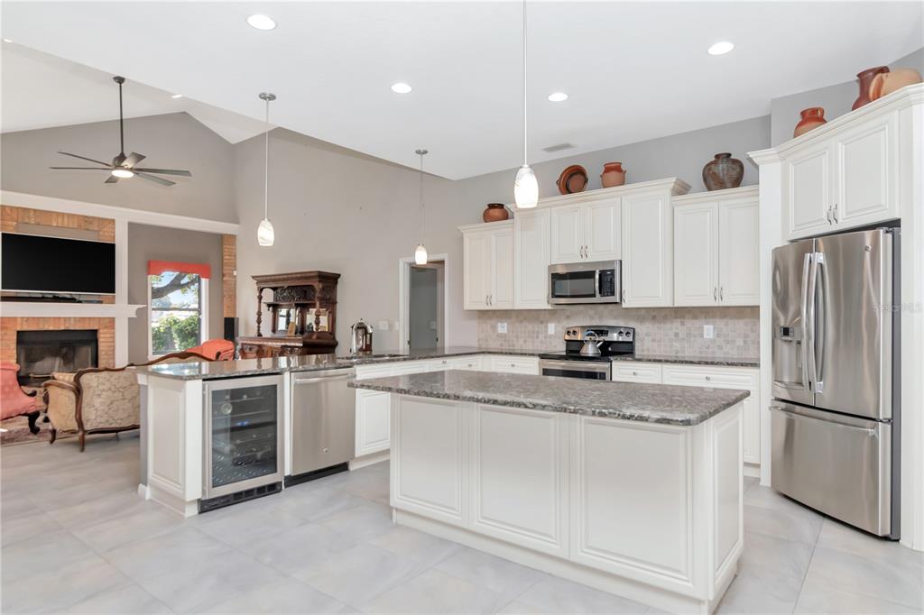 4511 Country Gate Court Valrico, FL 33596 - Photo 12 of 64 a kitchen with stainless steel appliances granite countertop a refrigerator oven a sink dishwasher and a refrigerator with white cabinets