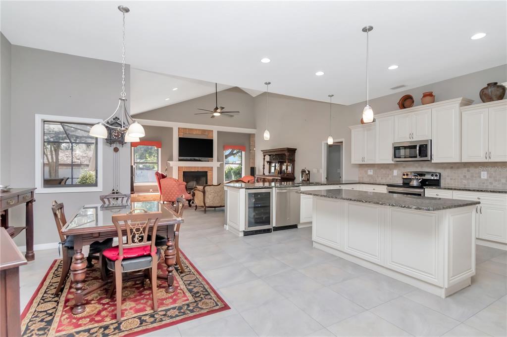 4511 Country Gate Court Valrico, FL 33596 - Photo 15 of 64 a living room with stainless steel appliances kitchen island furniture and a fireplace