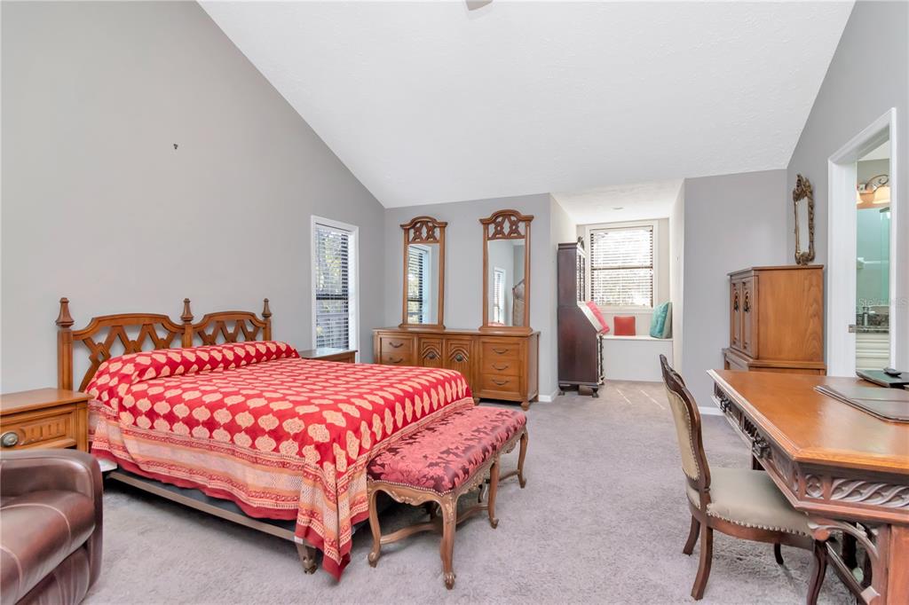 4511 Country Gate Court Valrico, FL 33596 - Photo 36 of 64 a bedroom with a bed a table and chair