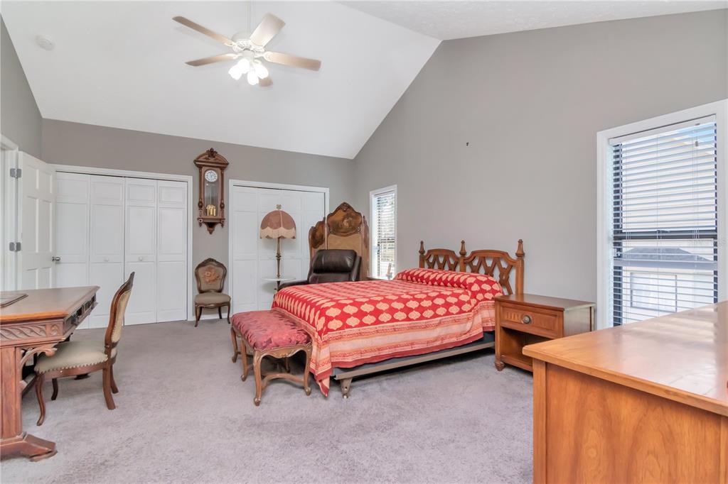 4511 Country Gate Court Valrico, FL 33596 - Photo 37 of 64 a bedroom with 2 bed table and chair