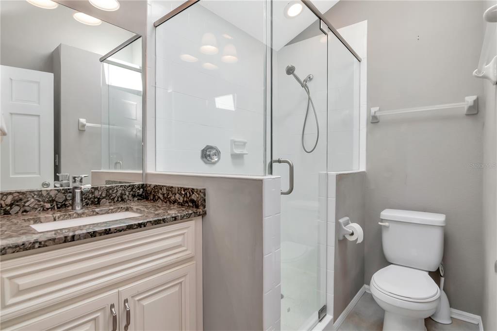 4511 Country Gate Court Valrico, FL 33596 - Photo 38 of 64 a bathroom with a granite countertop sink toilet and shower